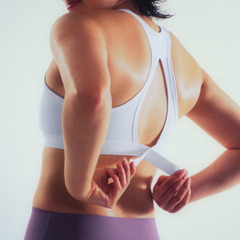 A person posing in a Nike sports bra