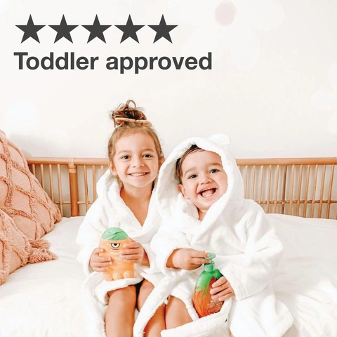 kids sitting on bed in robes holding raw sugar products and smiling