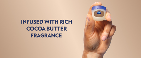 Hand holding a small pot of Vaseline Lip Therapy Jelly &amp; text about infused cocoa butter fragrance.
