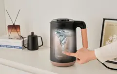 A person pressing the self-cleaning button on a nut milk maker, with a transparent view of the inside as the self-cleaning function is activated and working.