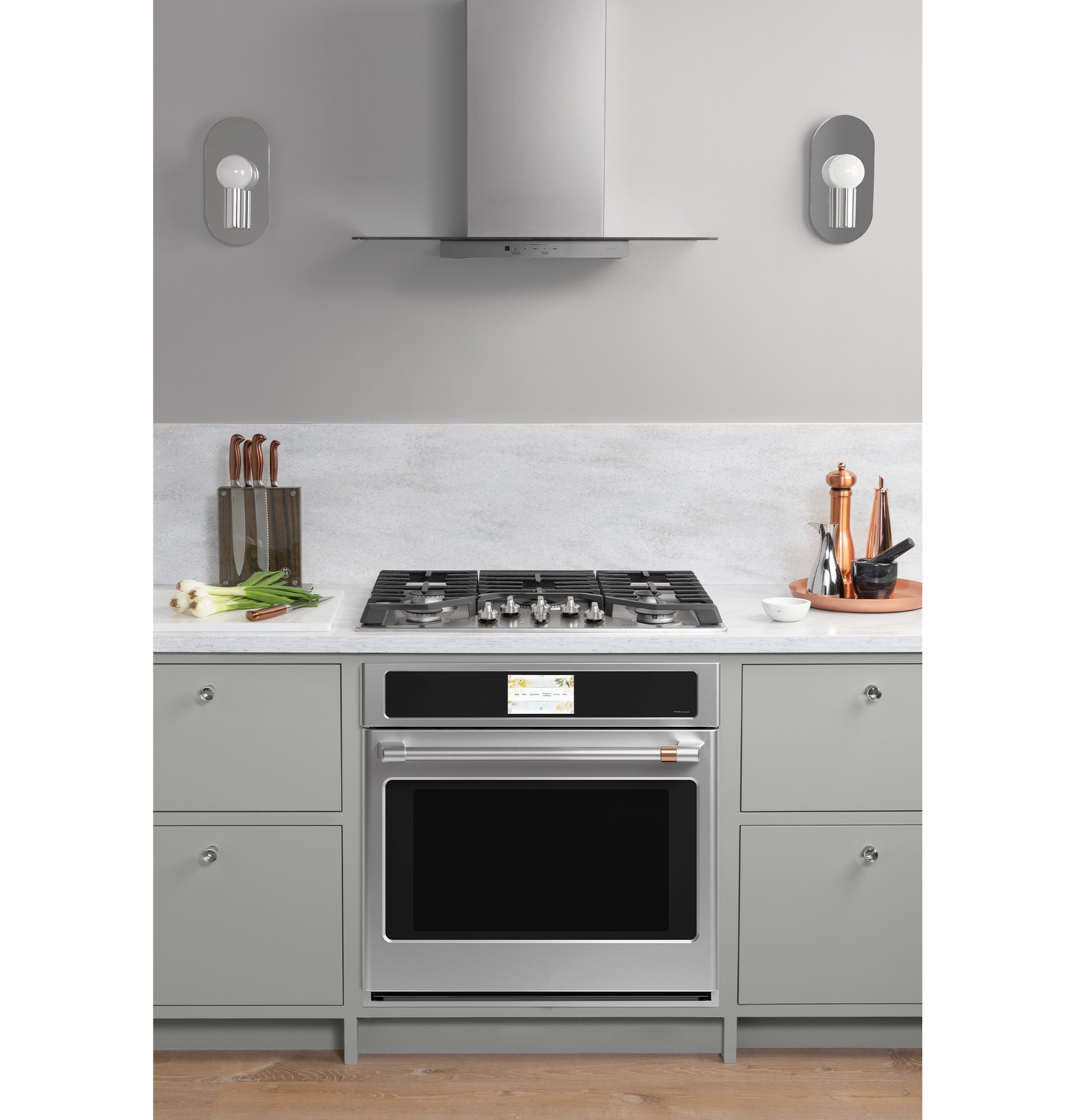 Kitchen vent hood layout Chef cooking under a powerful wall mount canopy hood