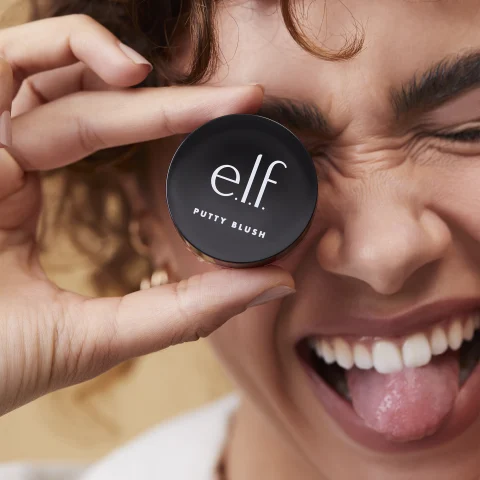 Model holding Putty Blush in hand