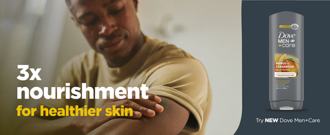 A man touches his arm, with Dove Men+Care Body Wash on a dark background beside him.