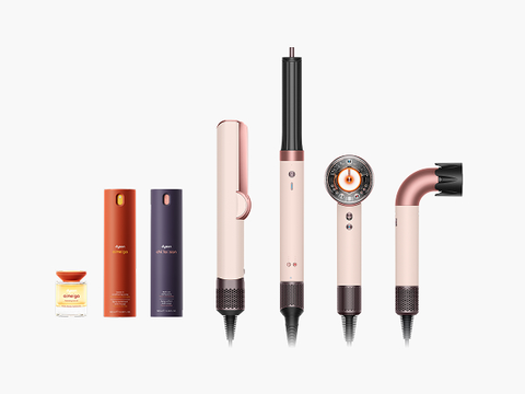 Dyson nourishing and styling beauty collection products in a row next to Dyson styling machines
