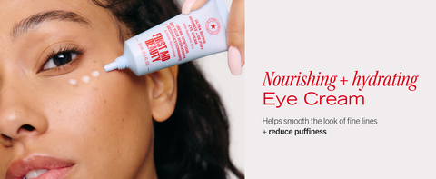 Woman with three dots of eye cream on her undereye area