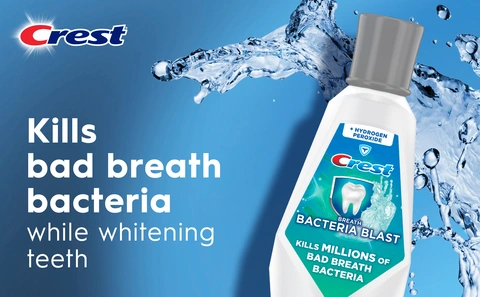 Crest Breath Bacteria Blast Rinse kills bad breath bacteria while whitening teeth and the bottle is displayed on the right side surronded by a splash of water.