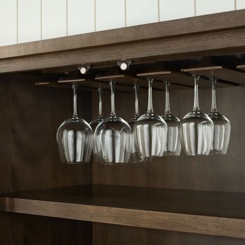 Detail of the five rows of slotted wood rail hanging stemware storage