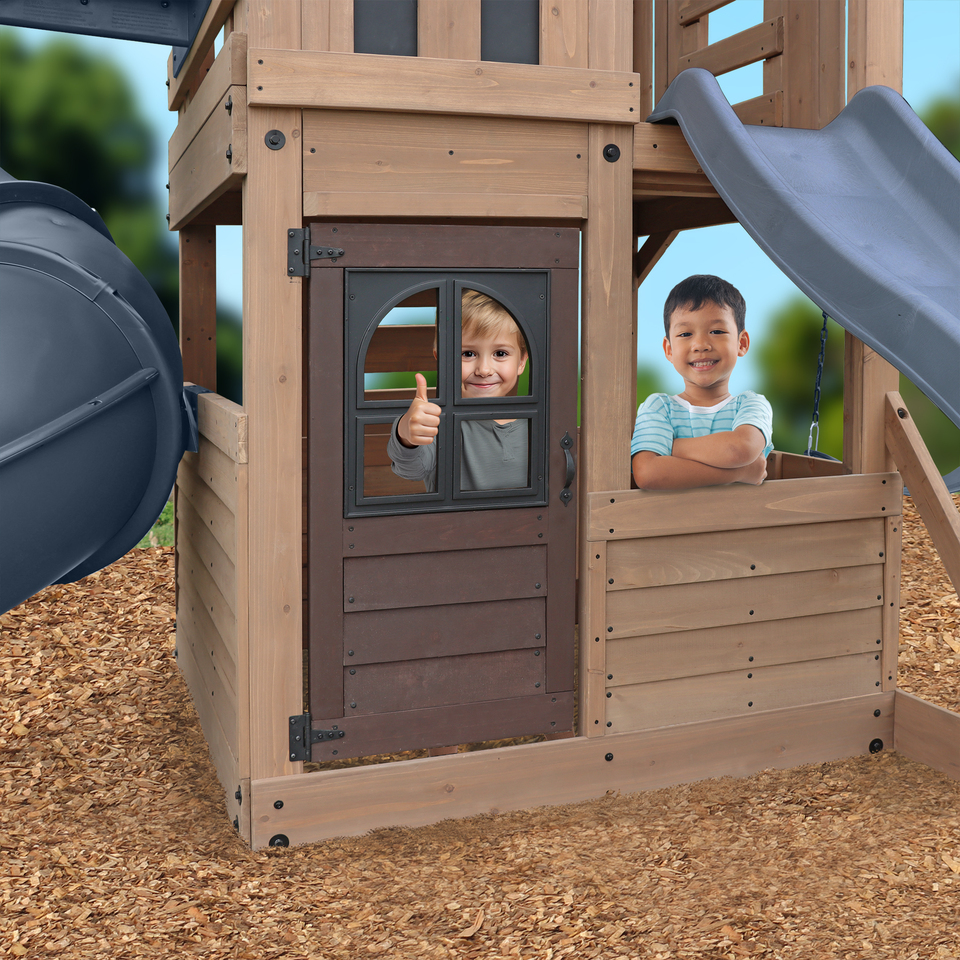 Close up of kids in clubhouse of Skyline Lookout Swing Set