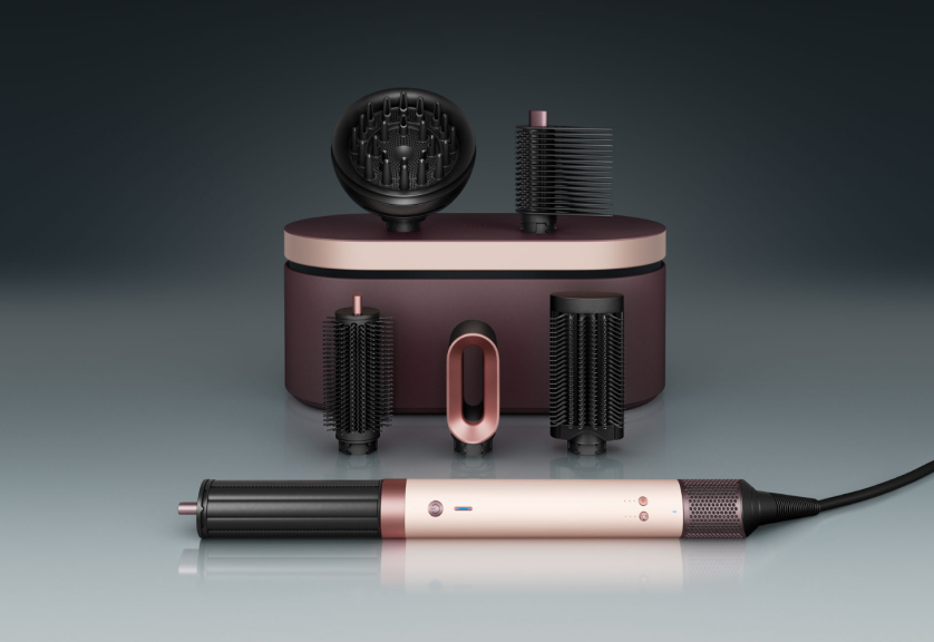 The Dyson Airwrap Co-anda2x multi-styler and dryer in front of a presentation case with a range of accessories.