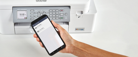 Person using mobile app on smartphone to manage printers