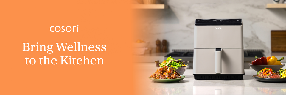On a banner, text beside an image of a mostly oyster white, boxy air fryer on a counter amid various foods reads, “Cosori. Bring Wellness to the Kitchen.”