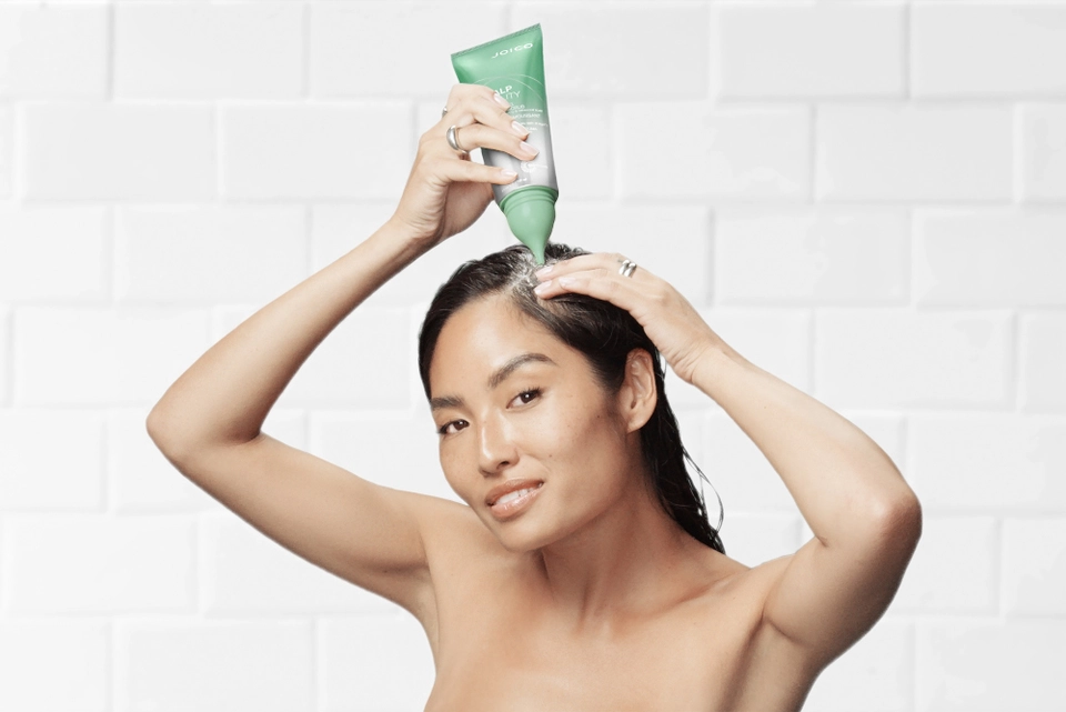model putting product onto scalp