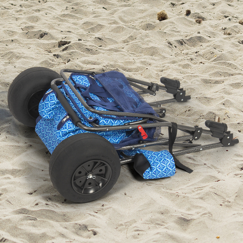 Cart folded flat, laying on the sand.