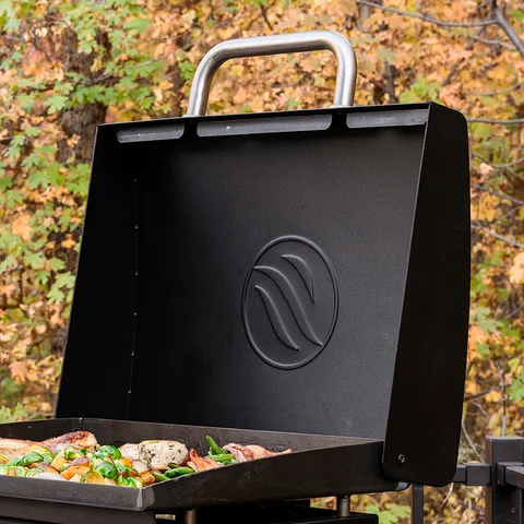 Griddle Hood shown open with food cooking on the griddle top.