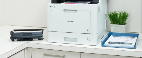 Brother laser printer on corporate shared printing station with toner cartridge