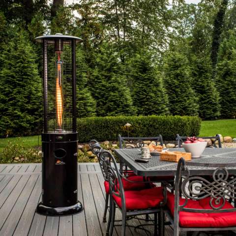 Paragon Outdoor Illume Patio Heater on wooden deck next to outdoor dining table set for breakfast.