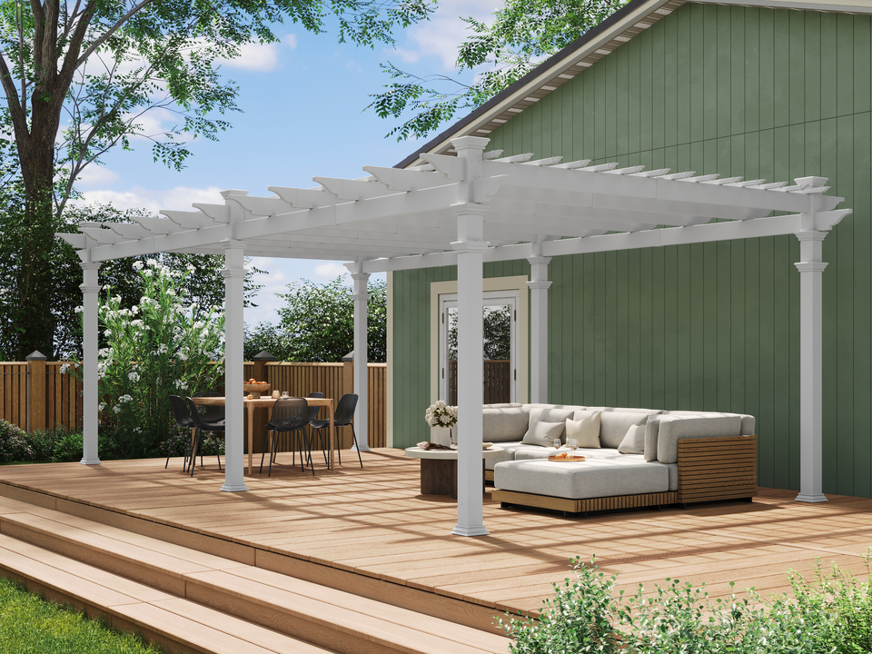 White pergola on a wooden deck with a seating area underneath