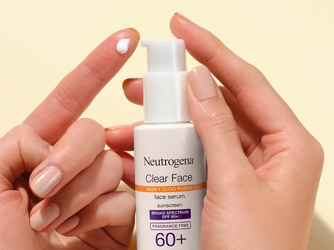 Woman pumping Neutrogena Clear Face Serum Sunscreen onto her finger