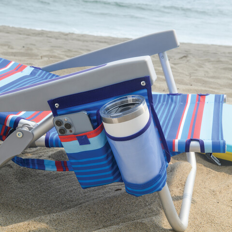 Travel mug in beverage holder and cell phone in pocket on side of chair.