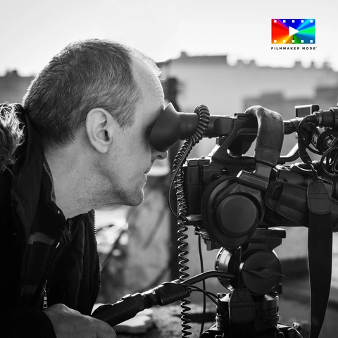 man looking through a pro camera