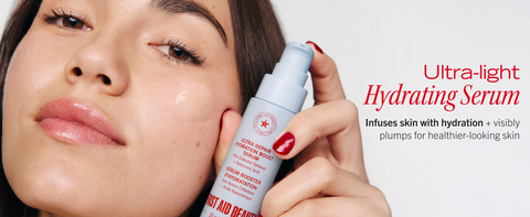 Model holding Ultra light hydrating serum near her cheek with swipe of texture