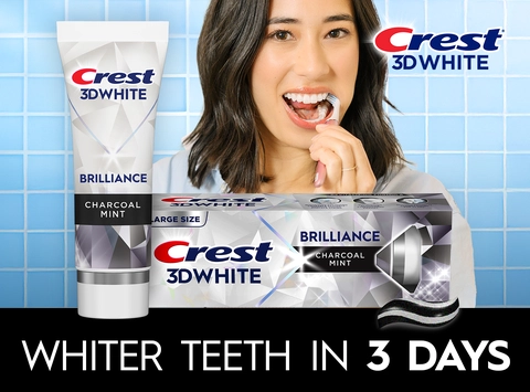 Happy woman brushing her teeth with Crest 3DWhite. Whiter Teeth in 3 Days.