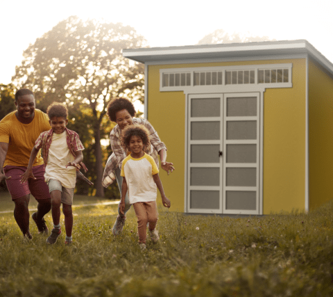 Family in front of Montague shed in backyard