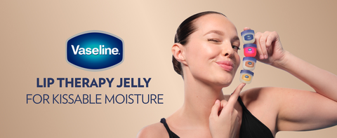 Image of a woman holding 4 small pots of Vaseline Lip Therapy Jelly, each of one kind.