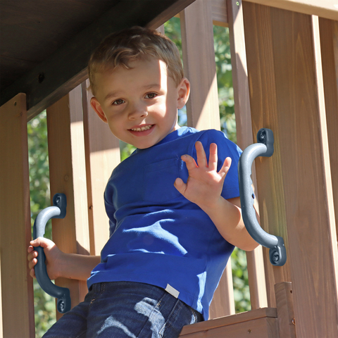 Kid sitting in play deck on Skyline Lookout Swing Set