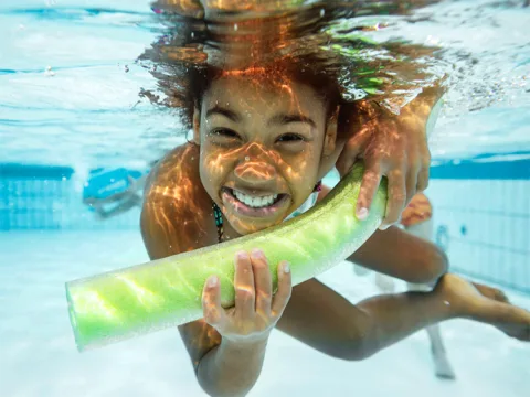 girl swimming under water