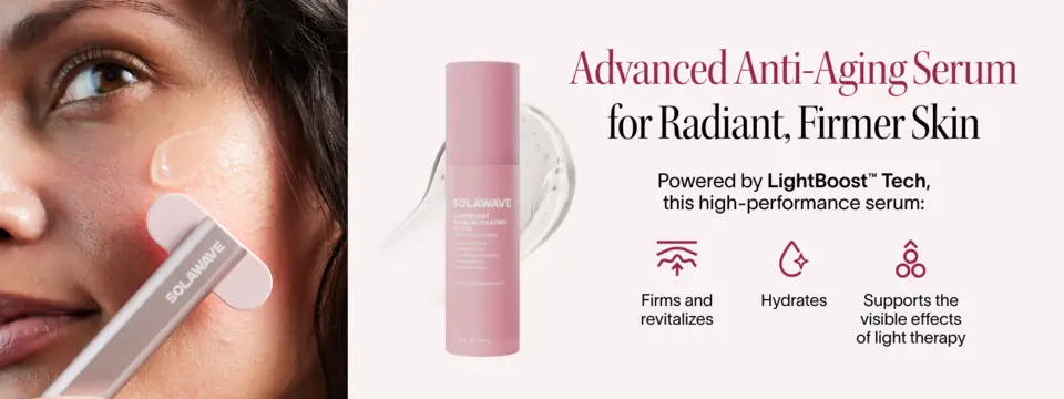 Person applying Solawave LightBoost Wand Activating Serum on cheek beside product bottle.