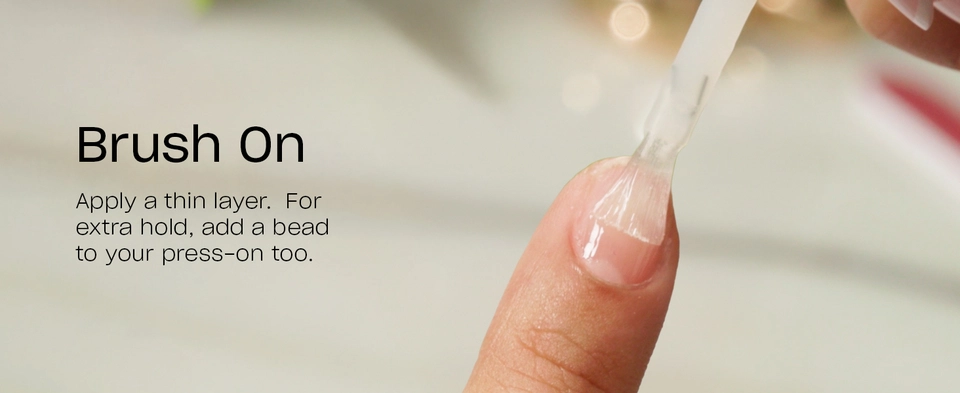 Brush glue on press-on nail and fingernail