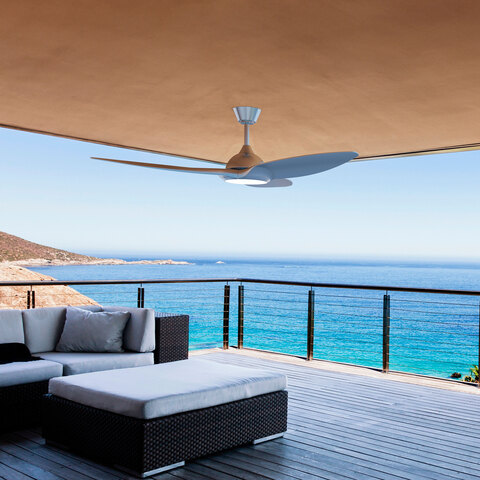 The smart ceiling fan mounted on a balcony ceiling overlooking a body of water