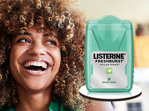 Woman smiling because Listerine Cool Mint PocketPak breath strips give her fresh breath on-the-go