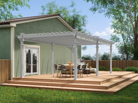 A seating area on a wooden deck underneath a white pergola