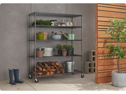 outdoor wire shelving rack filled with gardening tools and supplies