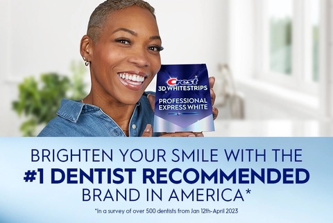 Woman smiling holding Crest 3DWhitestrips Professional Express White pack. Brighten Your Smile with the #1 Dentist Recommended Brand in America.