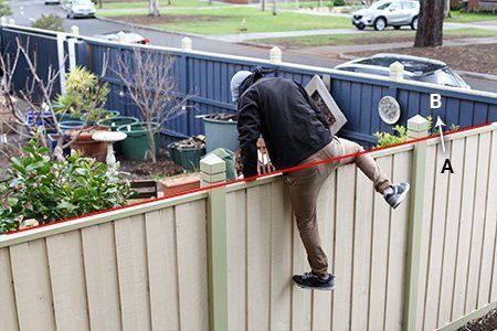 Man jumping over fence