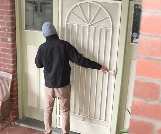 Man ringing a doorbell