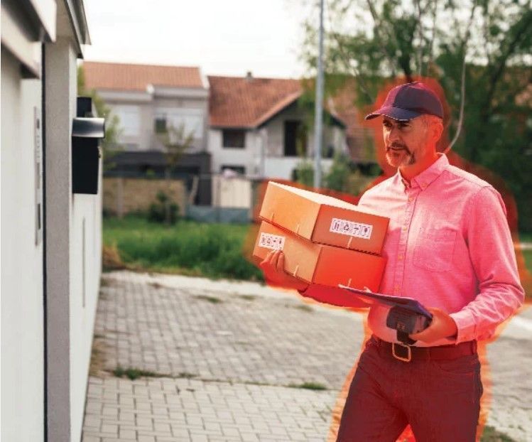 Delivery man highlighted red by a door
