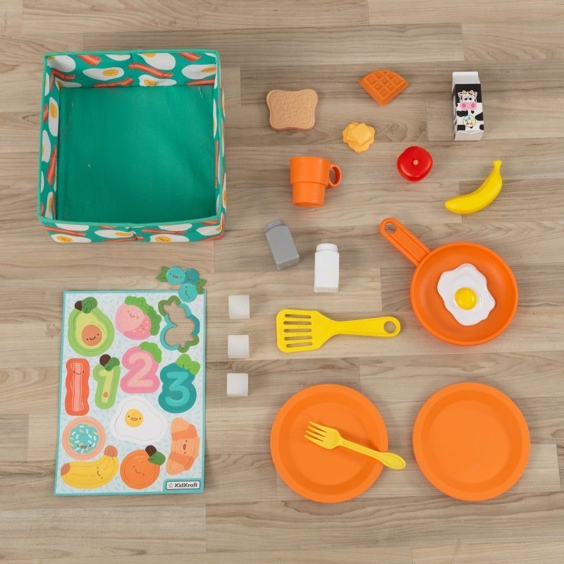 18 accessory pieces including play food, plates and utensils, 12 magnets, and fabric storage bin