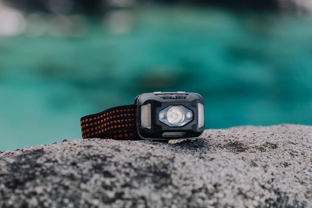 Image of the headlamp on a rock with water in the background